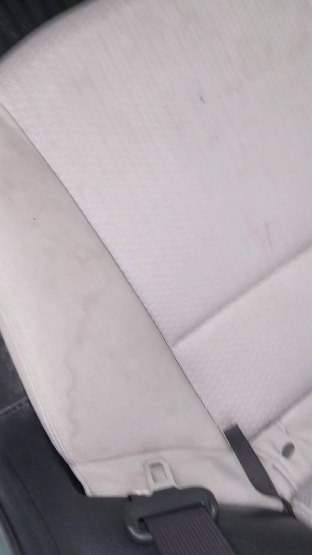 Stained cloth car seat before cleaning