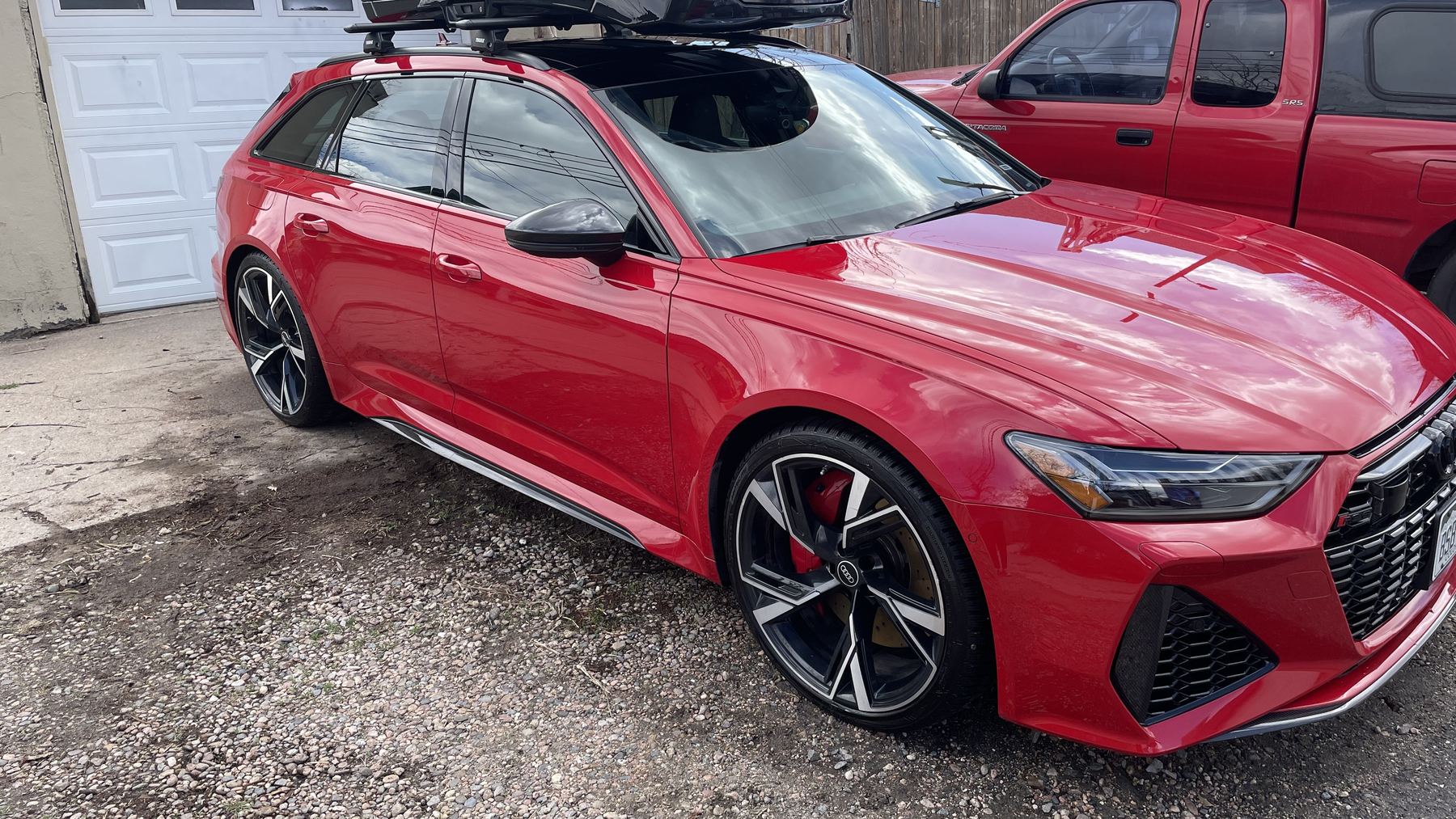 Freshly detailed red sport wagon parked outside after a full detail