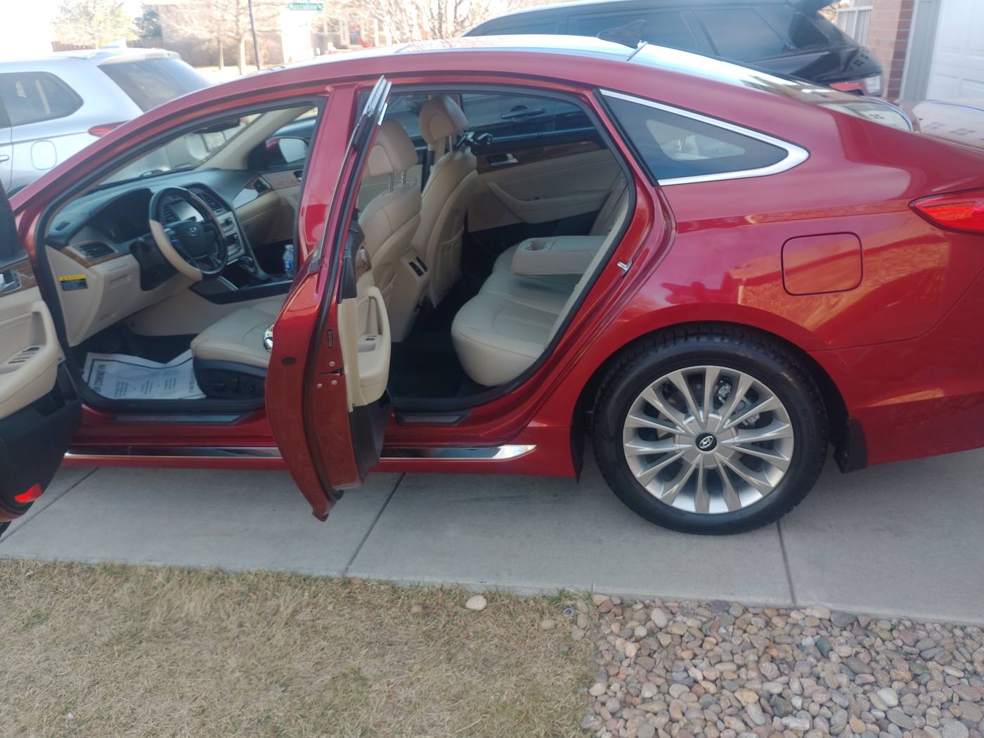 Red sedan with doors open showing a clean interior